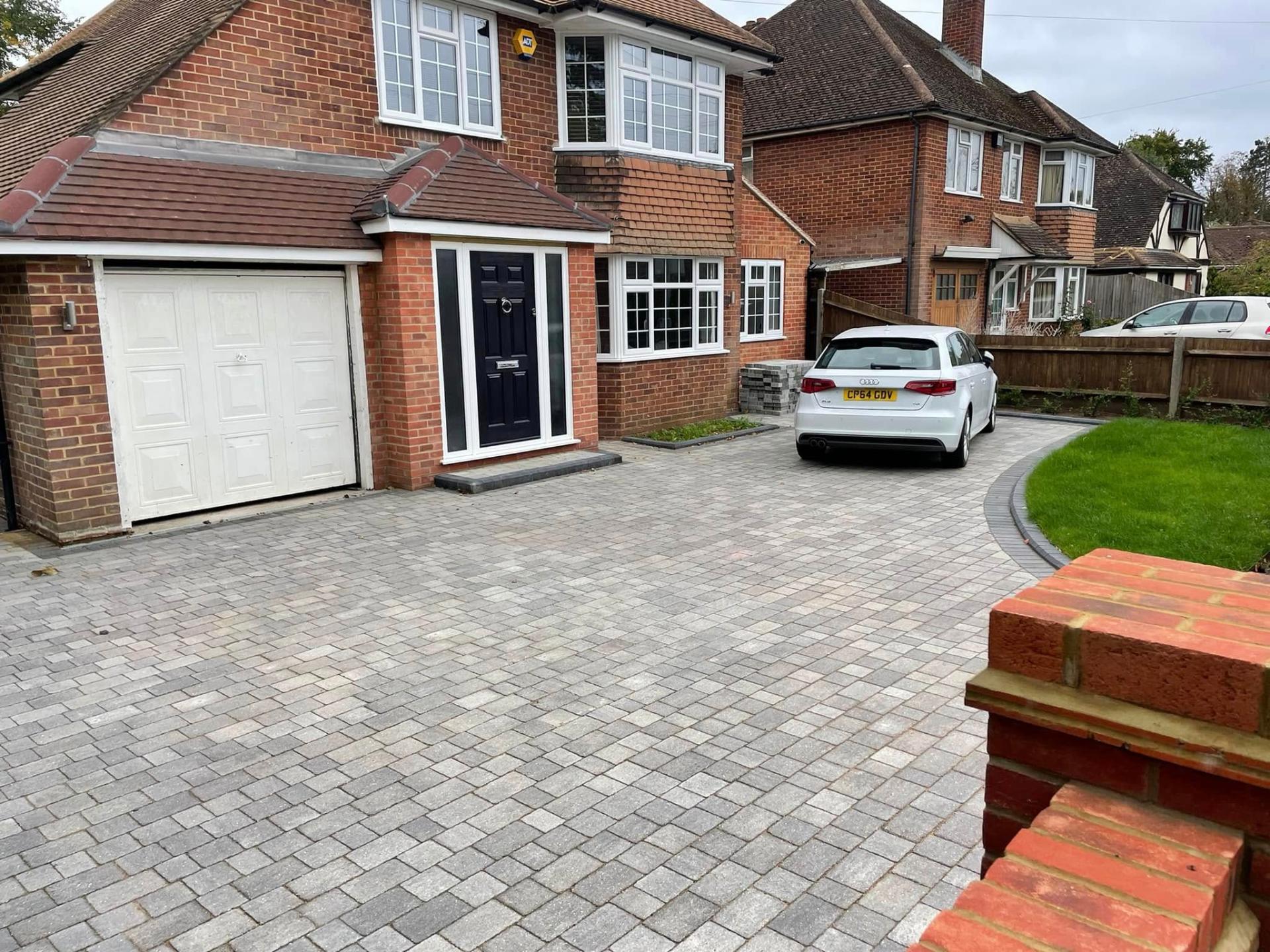 Block paving driveway with curved lawn