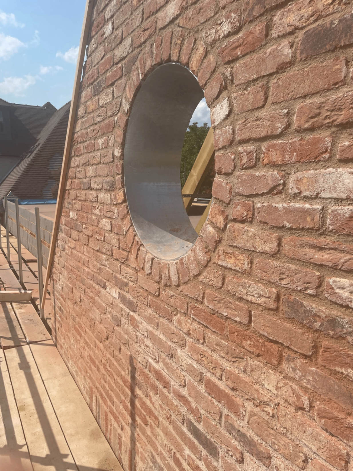 New brick wall construction with digger on site — Philbert Construction brickwork project in Reading & Berkshire
