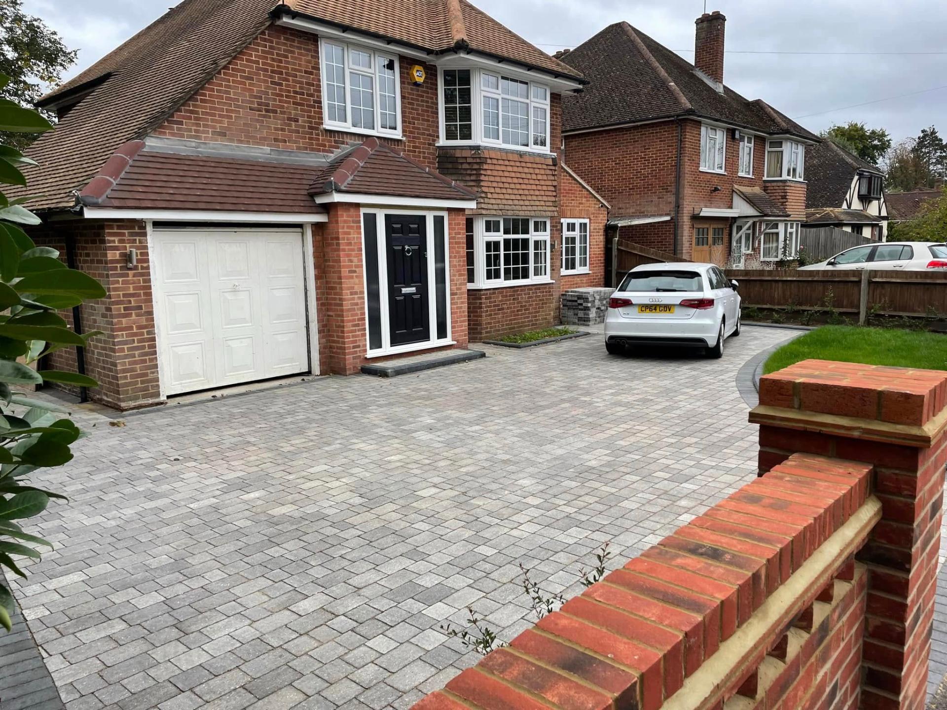 block paving driveway in front of brick house