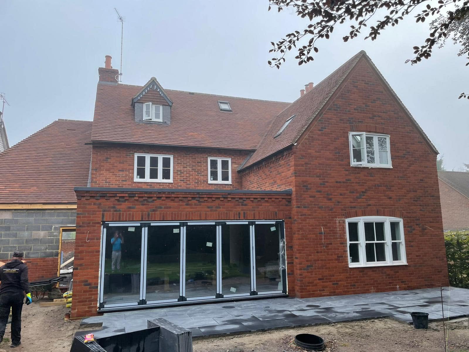 Large house extension with bi-fold doors and new patio area — Philbert Construction extensions project in Reading