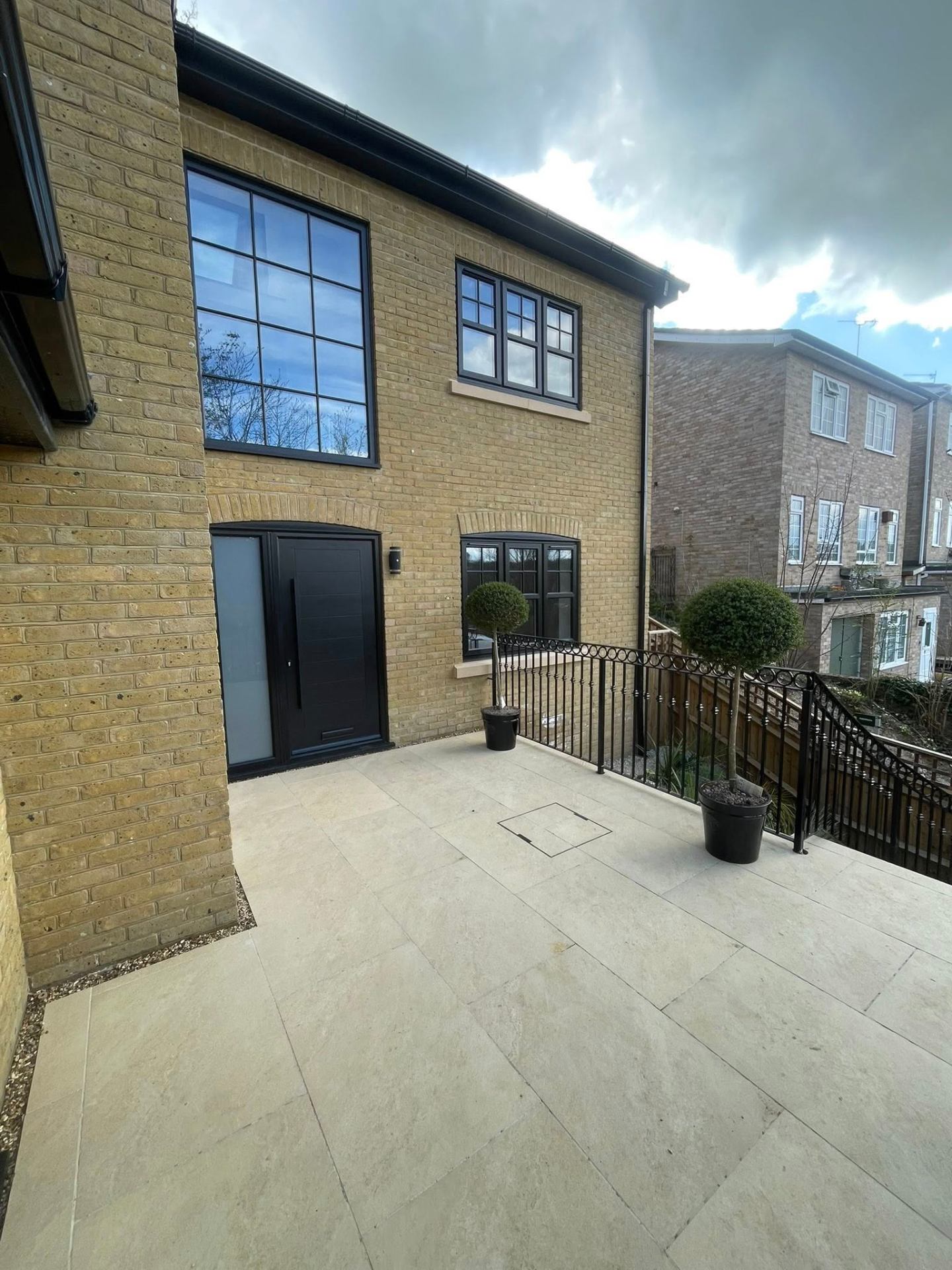 Paved area outside modern house. — Philbert Construction patios project in Reading & Berkshire