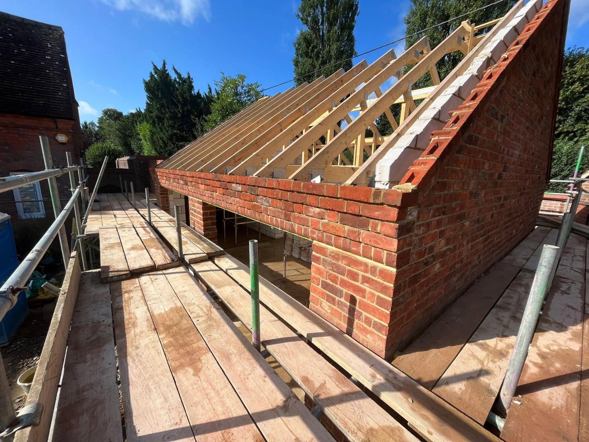 Extension under construction with roof trusses — Philbert Construction extensions project in Reading